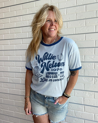 Women's Willie Nelson Austin 1976 graphic ringer tee with contrast navy trim, short sleeves, and a vintage-inspired Texas country music design.
