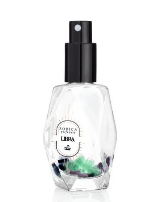 Perfume bottle with colorful crystals inside on a white background