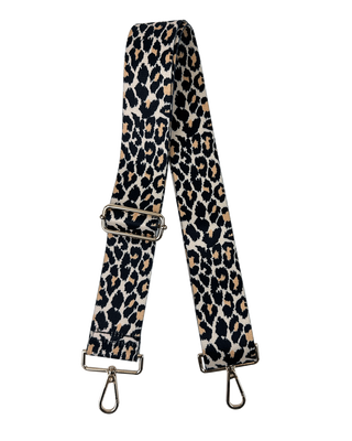 An adjustable cheetah print bag strap with gold hardware.